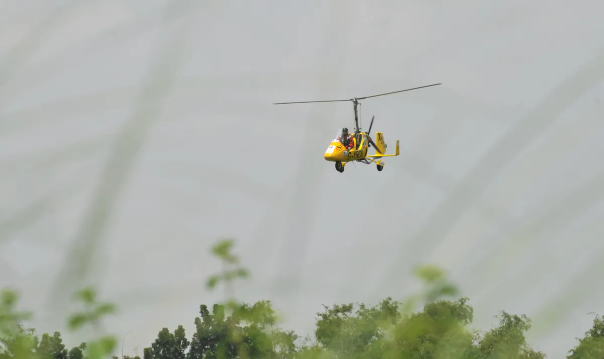 A pilot flies a gyrocopter in the Philippines on Sept. 6, 2010. TED ALJIBE/AFP via Getty Images)