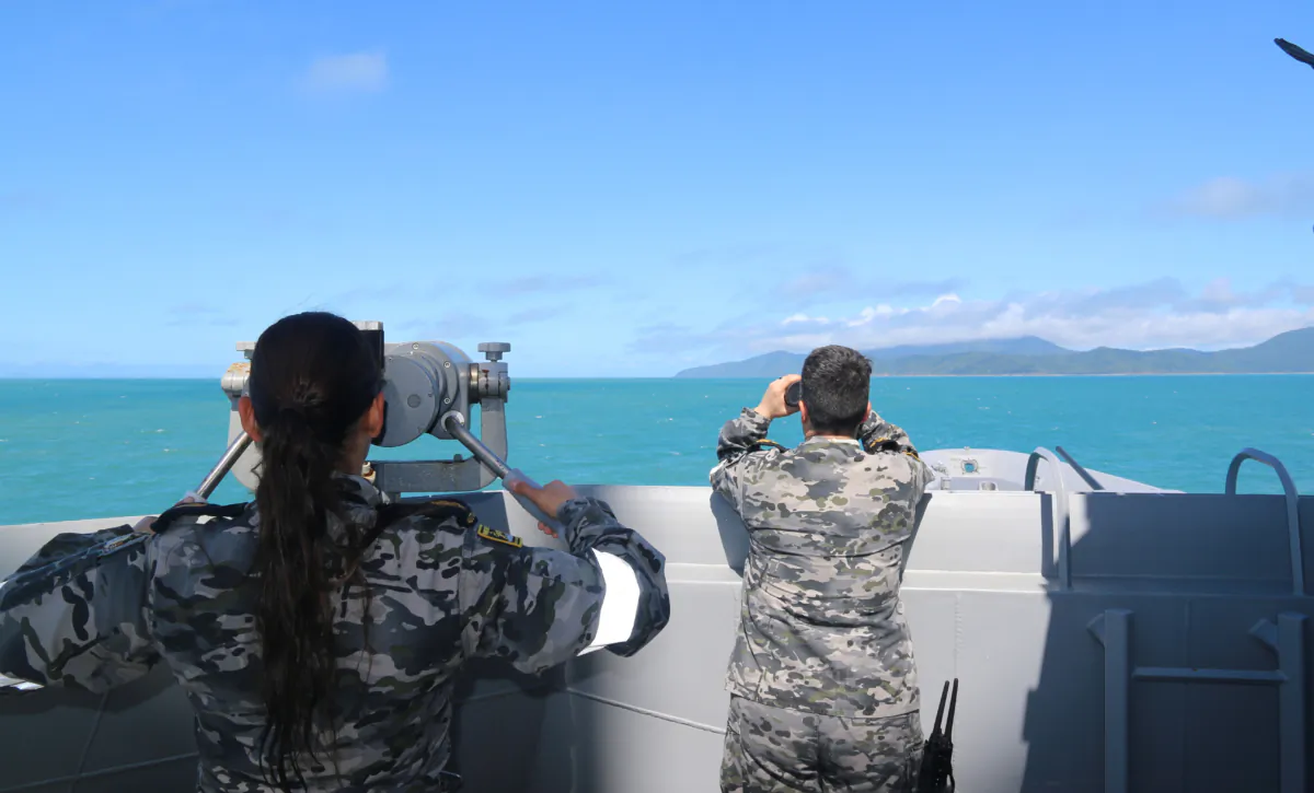 Royal Australian Navy sailors from HMAS Brisbane on the bridge wing scan the horizon during search and rescue operations in the vicinity of Lindeman Island, Queensland, on July 29, 2023. (AAP Image/Defence Imagery)