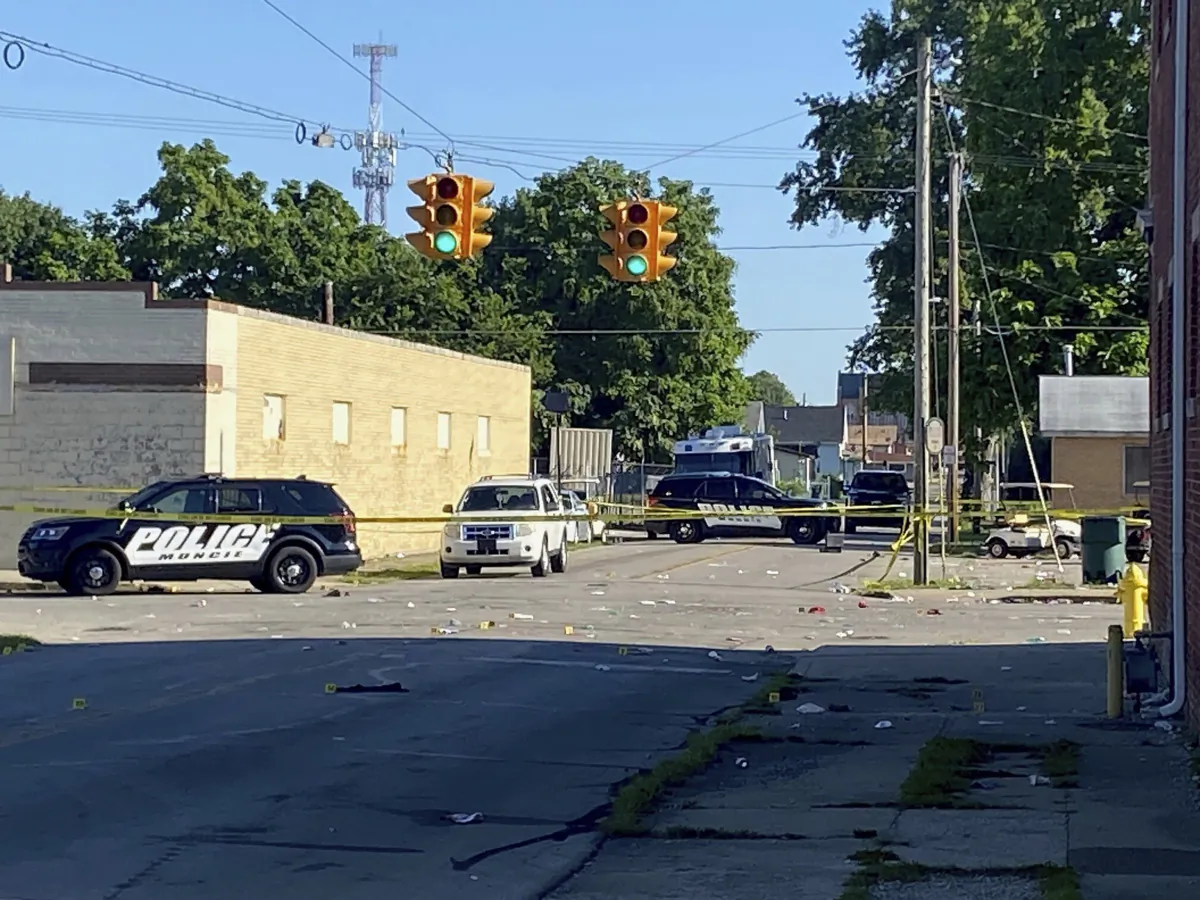 Police remain at the scene of a shooting in Muncie, Ind., on July 30, 2023. (Douglas Walker/The Star Press via AP)