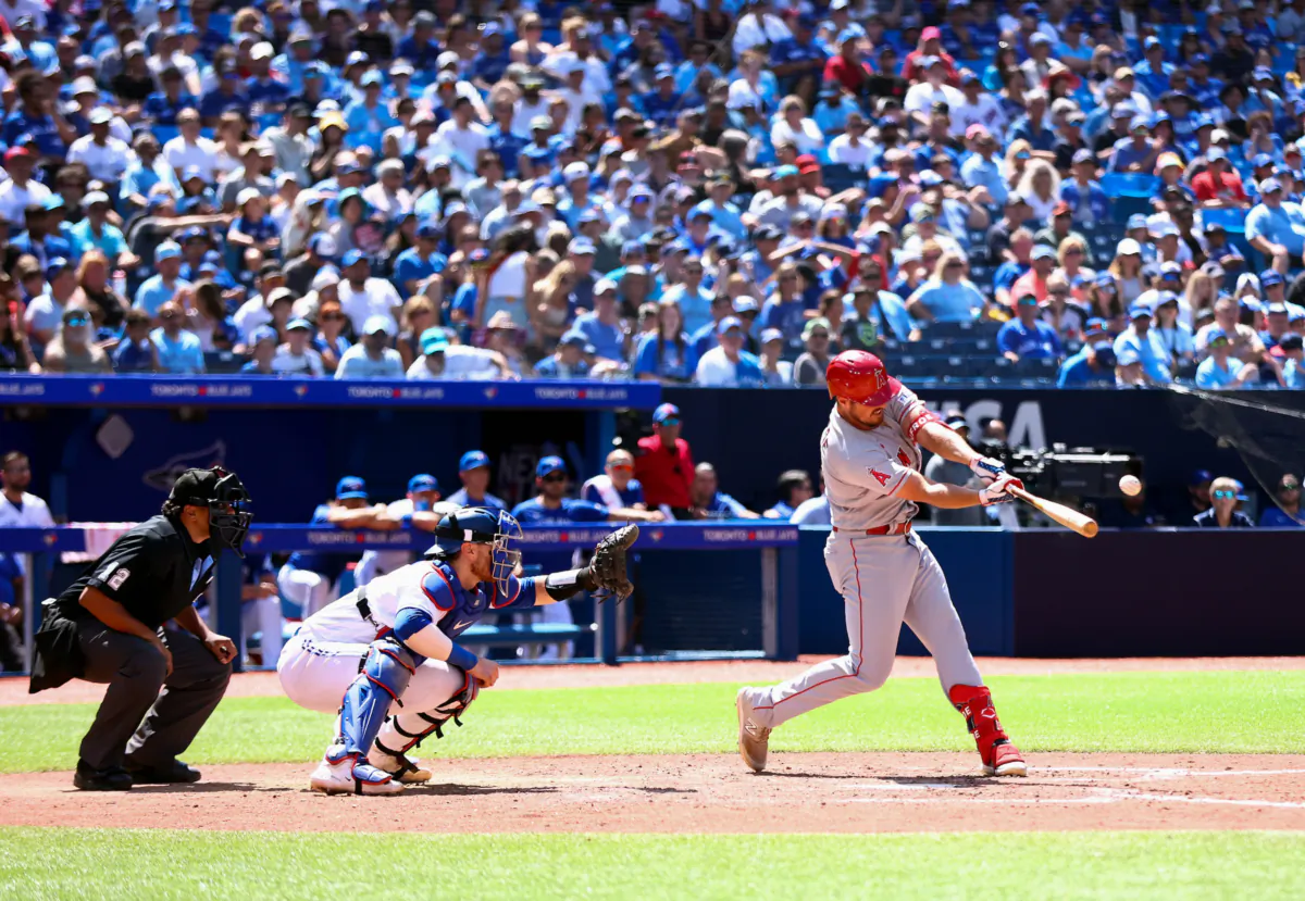 Hunter Renfroe (12) of the Los Angeles Angels hits a 2-run home run in the tenth inning against the Toronto Blue Jays at Rogers Centre in Toronto, Ontario, Canada, on July 30, 2023.  (Vaughn Ridley/Getty Images)