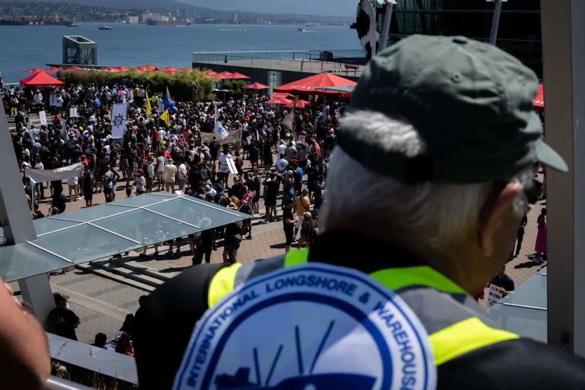 A striking port worker from the International Longshore and Warehouse Union Canada views the large gathering attending a rally in Vancouver, on July 9, 2023. (The Canadian Press/Ethan Cairns)