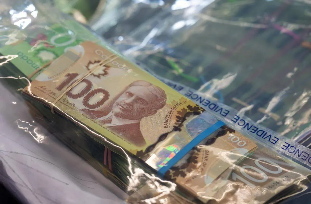 Money seized by police during a bust is displayed at RCMP headquarters in Surrey, B.C., on Dec. 7, 2022. (The Canadian Press/Jonathan Hayward)