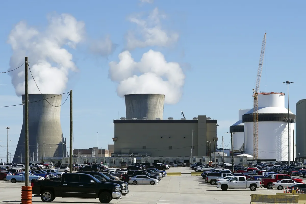 Reactors for Unit 3 and 4 sit at Georgia Power's Plant Vogtle nuclear power plant in Waynesboro, Ga., on Jan. 20, 2023, with the cooling towers of older Units 1 and 2 billowing steam in the background. (John Bazemore/AP Photo)