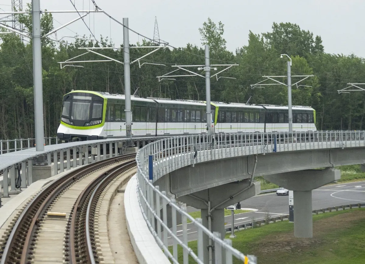 A Réseau express métropolitain (REM) light-rail system train is seen on the tracks, July 28, 2023, in Brossard, Que. (The Canadian Press/Christinne Muschi)
