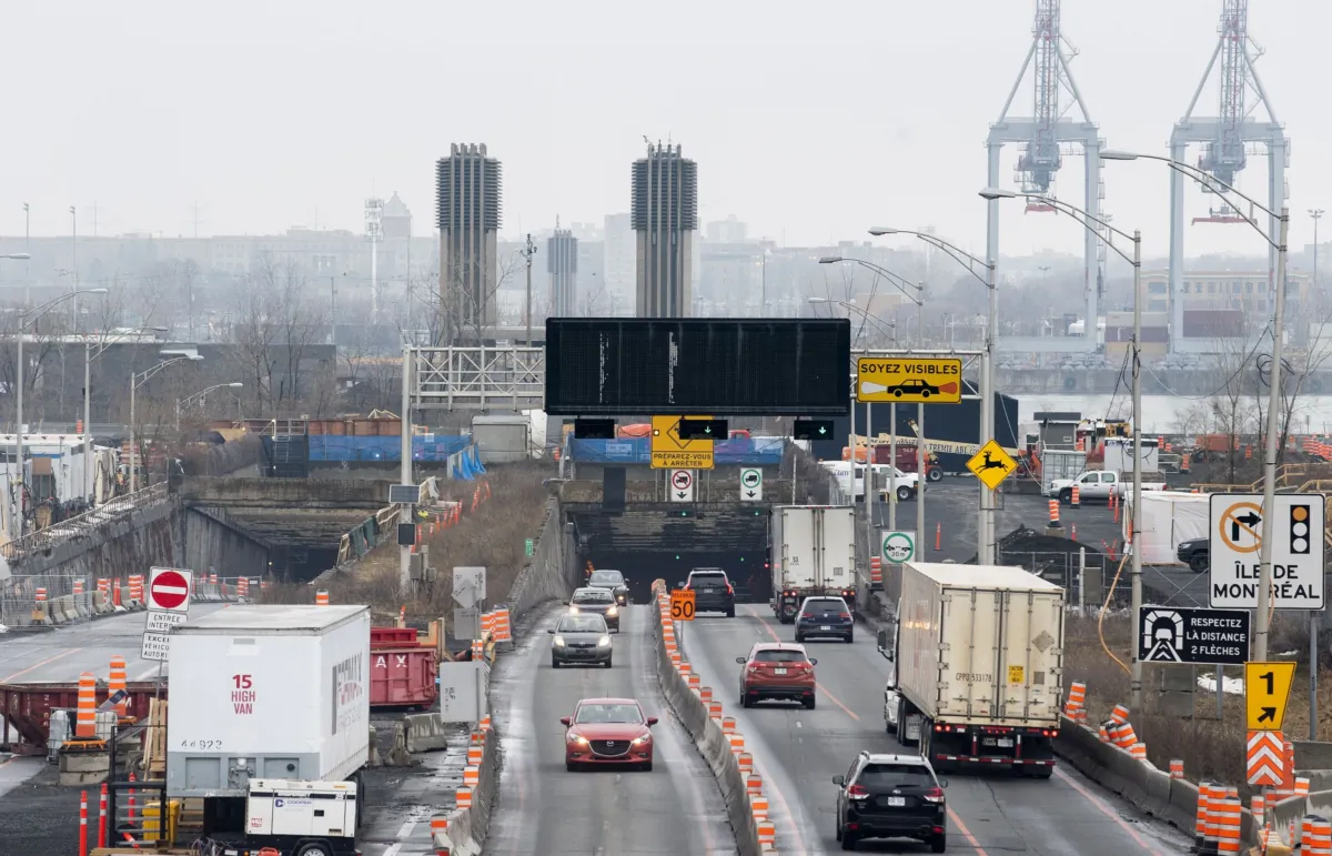 Trucks and other vehicles enter and exit the Louis-Hippolyte-La Fontaine Tunnel in Montreal on Jan. 2, 2023. (The Canadian Press/Graham Hughes)