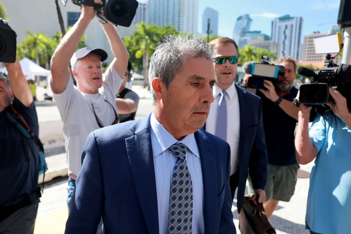 Carlos De Oliveira (C), a property manager for President Donald Trump's Mar-a-Lago estate, arrives with his lawyer John Irving at the James Lawrence King Federal Justice Building in Miami on July 31, 2023. (Joe Raedle/Getty Images)