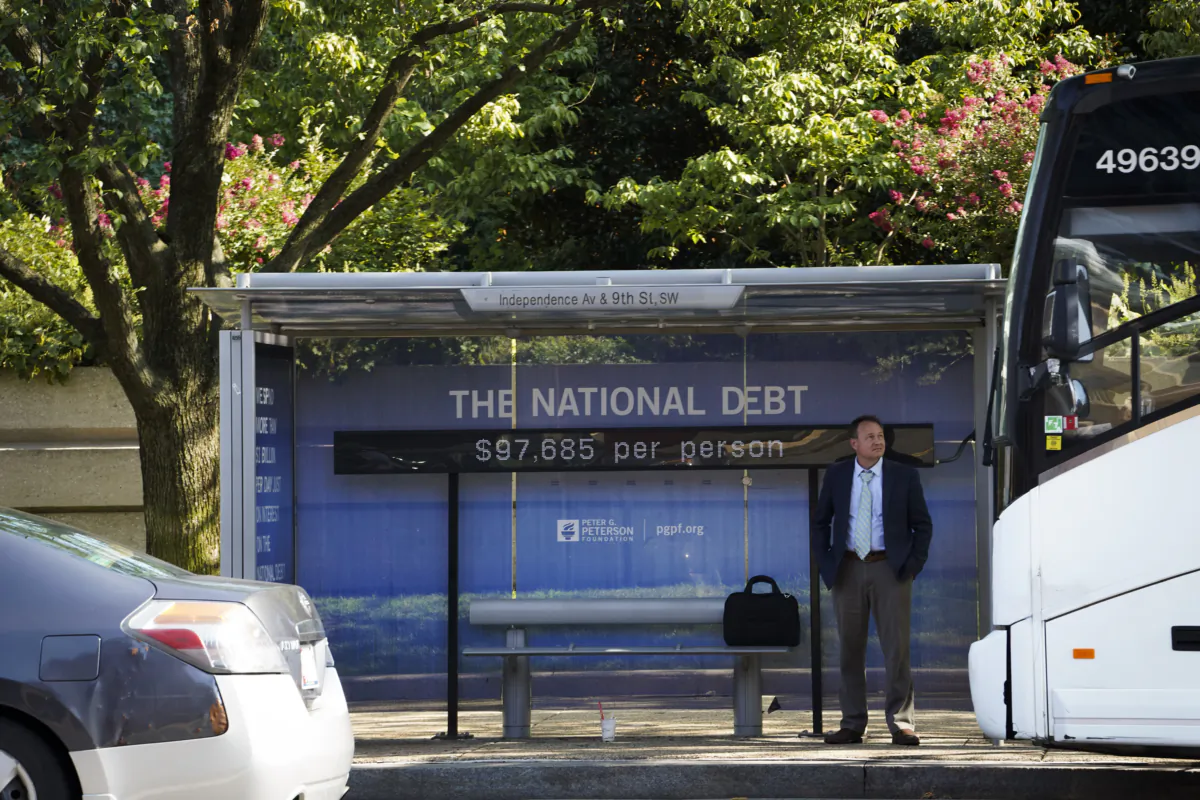 The National Debt Clock is seen at a bus stop in Washington on July 31, 2023. (Madalina Vasiliu/The Epoch Times)