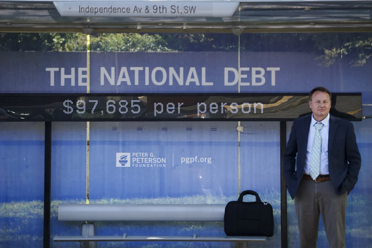 The National Debt Clock is seen at a bus stop in Washington on July 31, 2023. (Madalina Vasiliu/The Epoch Times)