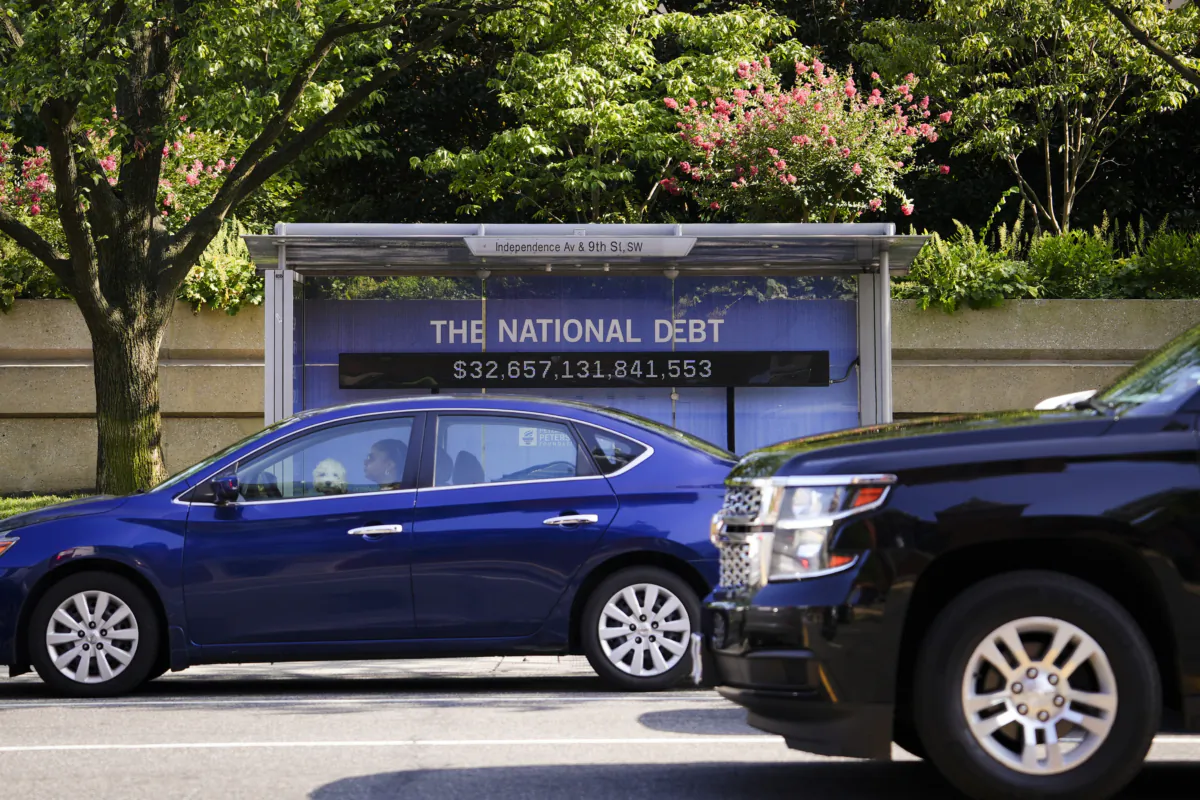The National Debt Clock is shown at a bus stop in Washington on July 31, 2023. (Madalina Vasiliu/The Epoch Times)