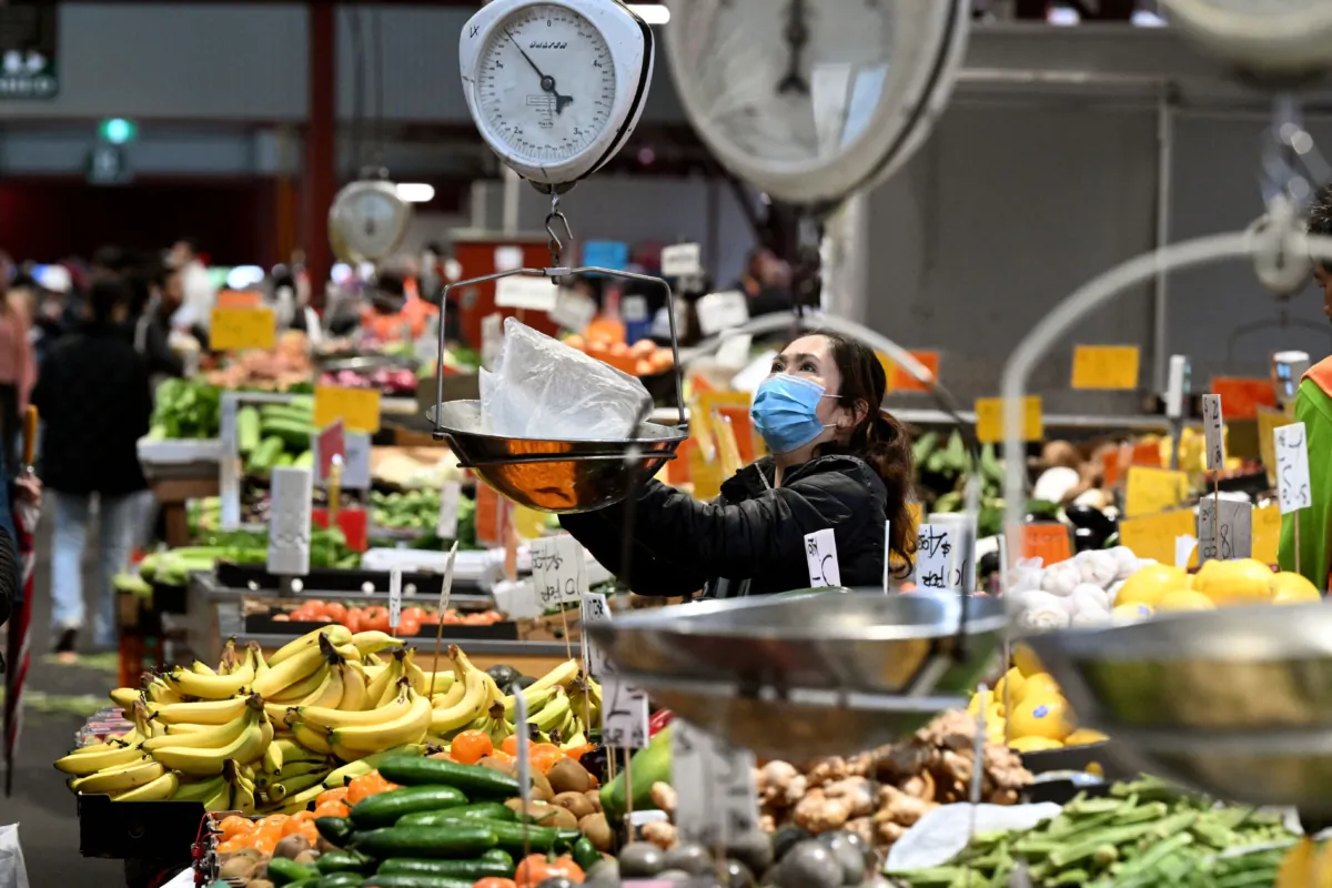 A vendor weighs fresh produce at the Queen Victoria Market in Melbourne, Australia, on July 4, 2023. (William West/AFP via Getty Images)
