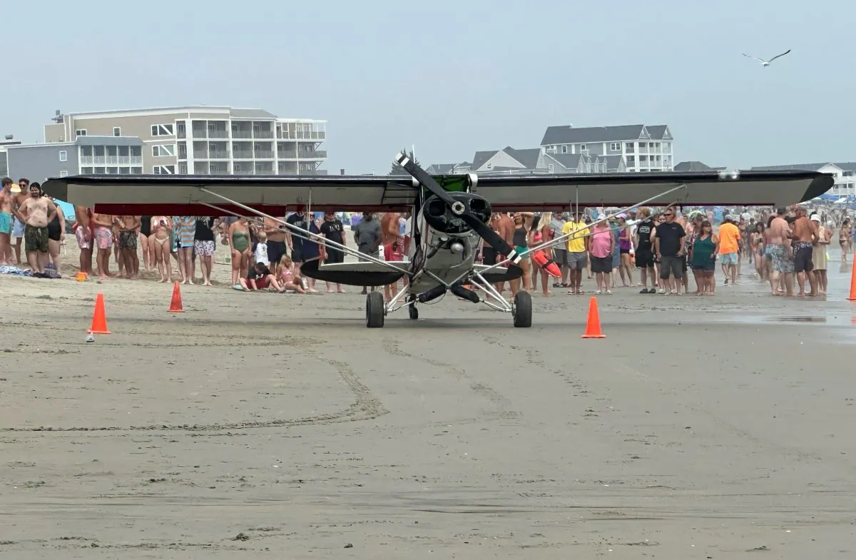 A small plane sits on the beach after crashing, in Hampton Beach, N.H., on July 29, 2023. (Tammy Nowlan via AP)