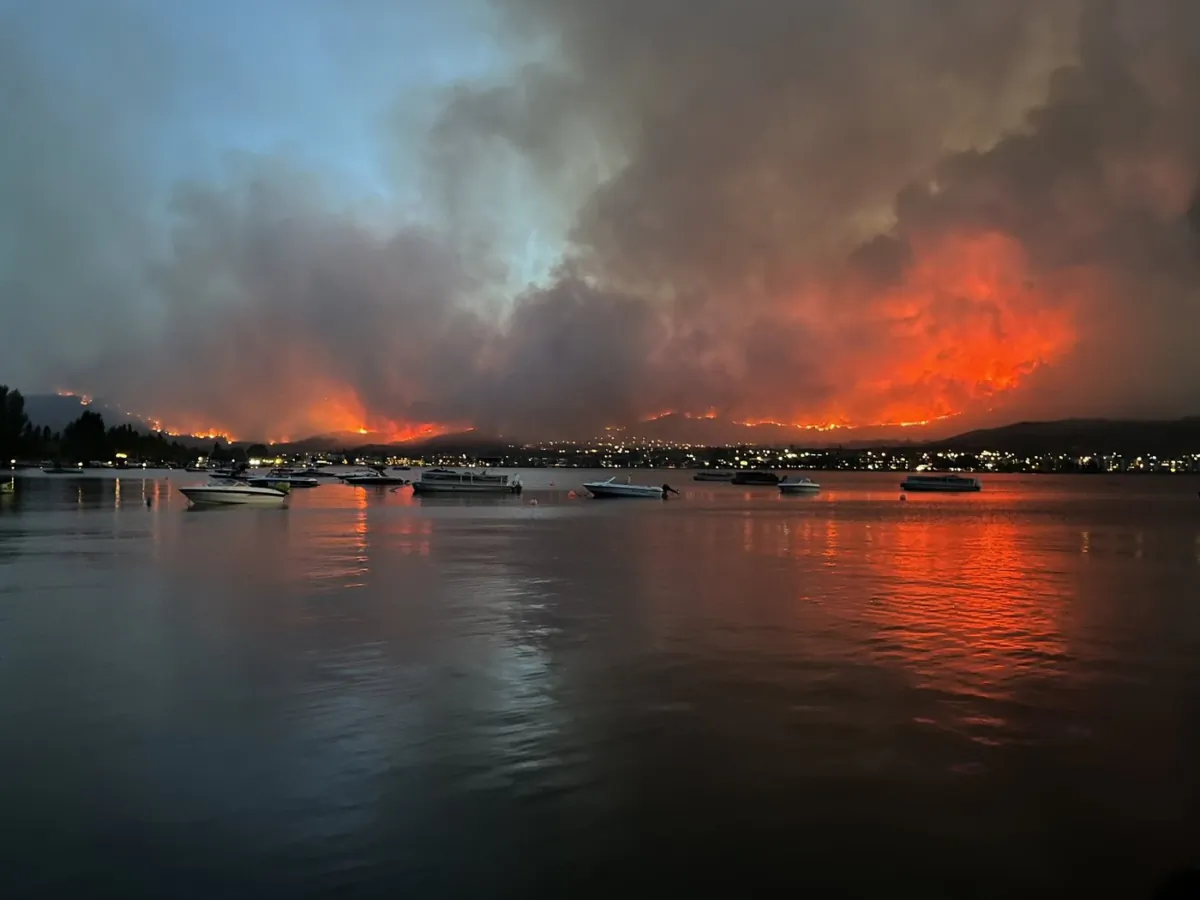 The Osoyoos fire is seen burning across the lake in Osoyoos, B.C., in a July 29, 2023, handout photo. (The Canadian Press/HO-Walter Wells)