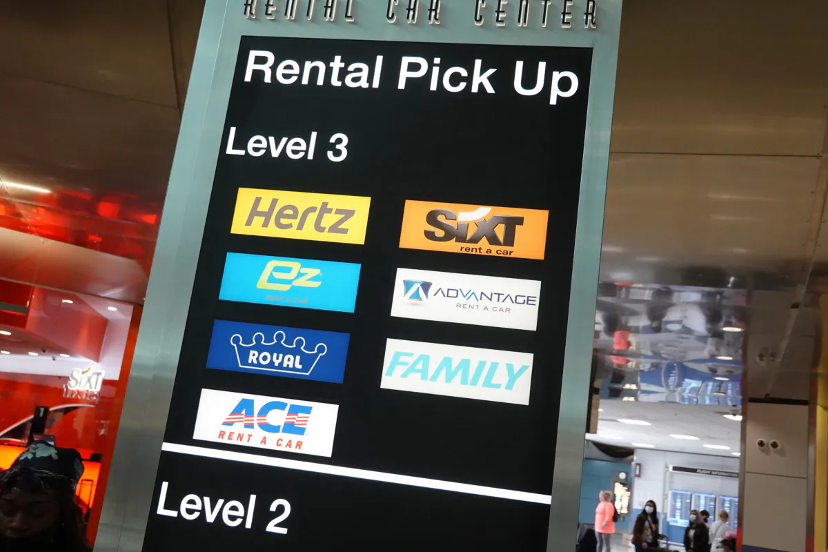 A sign indicates the rental pickup area at the Miami International Airport Car Rental Center on April 12, 2021, in Miami. (Joe Raedle/Getty Images/TNS)