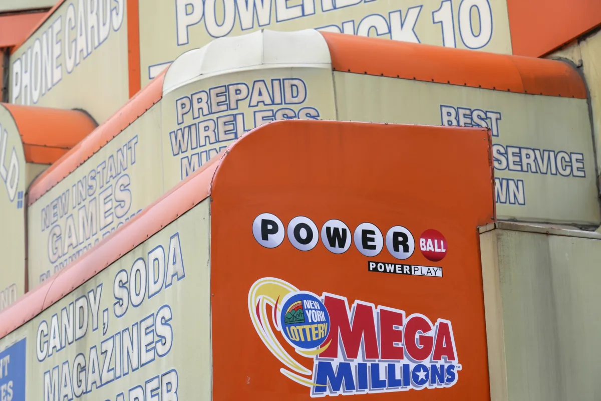The awnings of a store advertise the sale of lottery tickets, including Mega Millions, in New York on Jan. 11, 2023. (Seth Wenig/AP Photo)