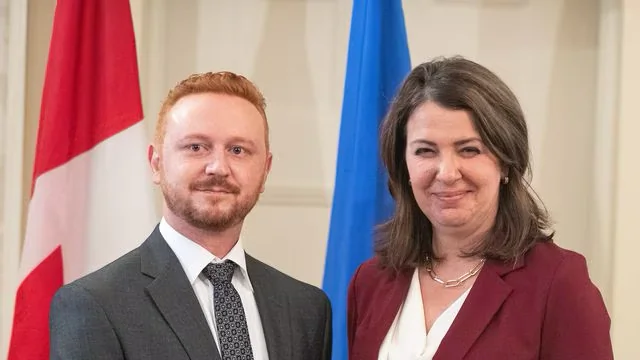 Alberta Premier Danielle Smith and Minister of Justice Mickey Amery stand together during the swearing in of her cabinet, in Edmonton on June 9, 2023. (Jason Franson/The Canadian Press)