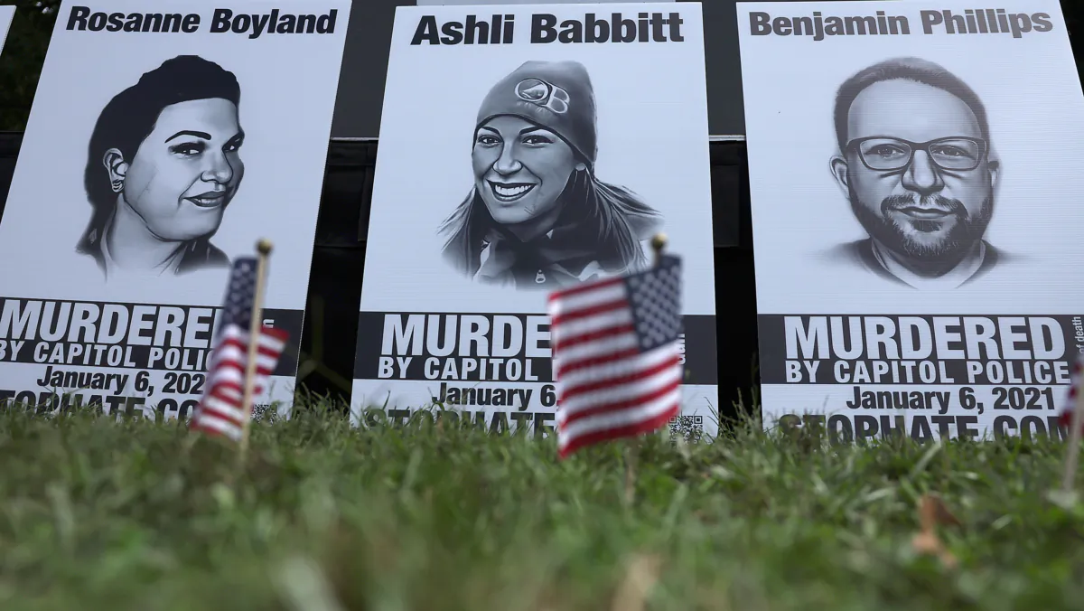Pictures of Rosanne Boyland, Ashli Babbitt, and Benjamin Philips, three of the four Trump supporters who died on Jan. 6, 2021, during a rally near the U.S. Capitol on Sept. 24, 2022. (Alex Wong/Getty Images)