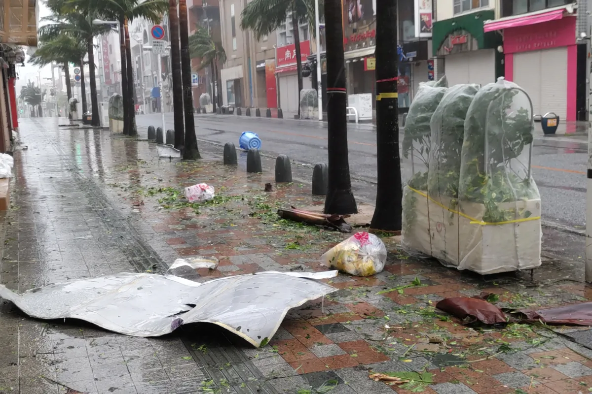 Scattered debris litters a downtown street as high winds brought by Typhoon Khanun hit the city of Naha, Okinawa prefecture on Aug. 2, 2023. (STR/JIJI Press/AFP via Getty Images)