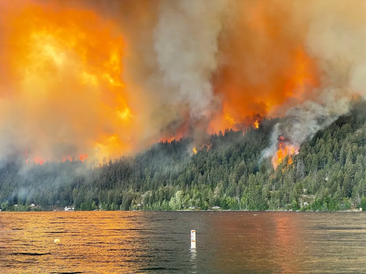 The Downton Lake wildfire near Gold Bridge B.C., burns toward the north shore of Gun Lake in this  Aug. 1, 2023 handout photo. (The Canadian Press/HO, Owen Rose)