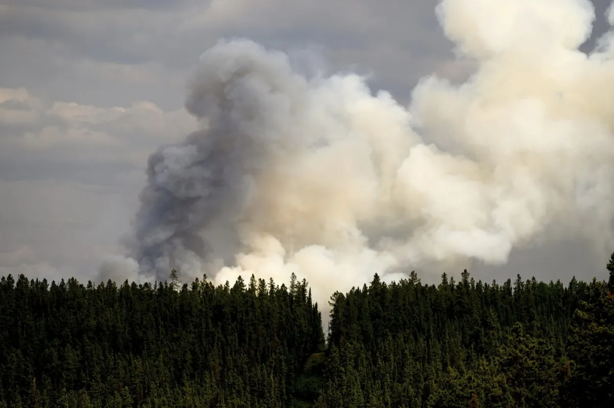 Smoke billows from the Donnie Creek wildfire burning north of Fort St. John, British Columbia, on July 2, 2023. (The Associated Press/Noah Berger)