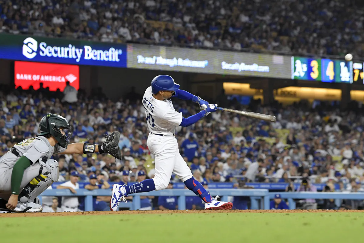 Los Angeles Dodgers' Mookie Betts, right, hits a solo home run as Oakland Athletics catcher Tyler Soderstrom watches during the seventh inning of a baseball game Lance Lynn gave up three home runs in his Dodgers debut, in Los Angeles on Aug. 1, 2023. (Mark J. Terrill/AP Photo)