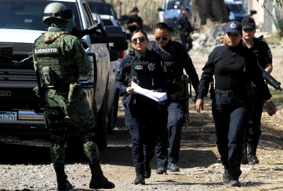 Members of the Mexican army and police work at the site of an explosive attack against a police patrol in Tlajomulco de Zúñiga, a suburb of Guadalajara, Mexico, on July 12, 2023. (Ulises Ruiz/AFP via Getty Images)