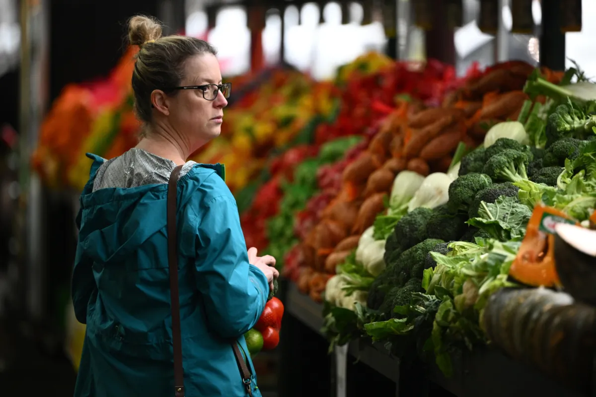 Members of the public shop for fresh produce at a market in Melbourne, Australia, on July 27, 2022. (AAP Image/Joel Carrett)