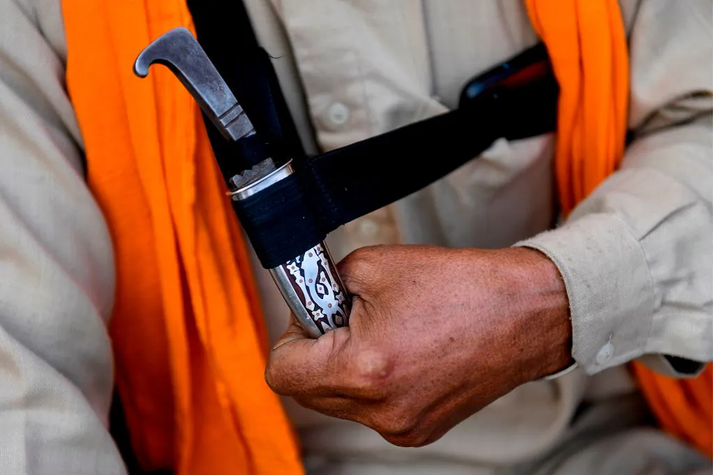 In this picture taken on Dec. 5, 2020 Sandeep Singh, a farmer from Rauni village in Ludhiana district of the northern Indian state of Punjab, holds his Kirpan, a sword or a dagger carried by Sikhs as a part of religious commandment. (Money Sharma/AFP via Getty Images)