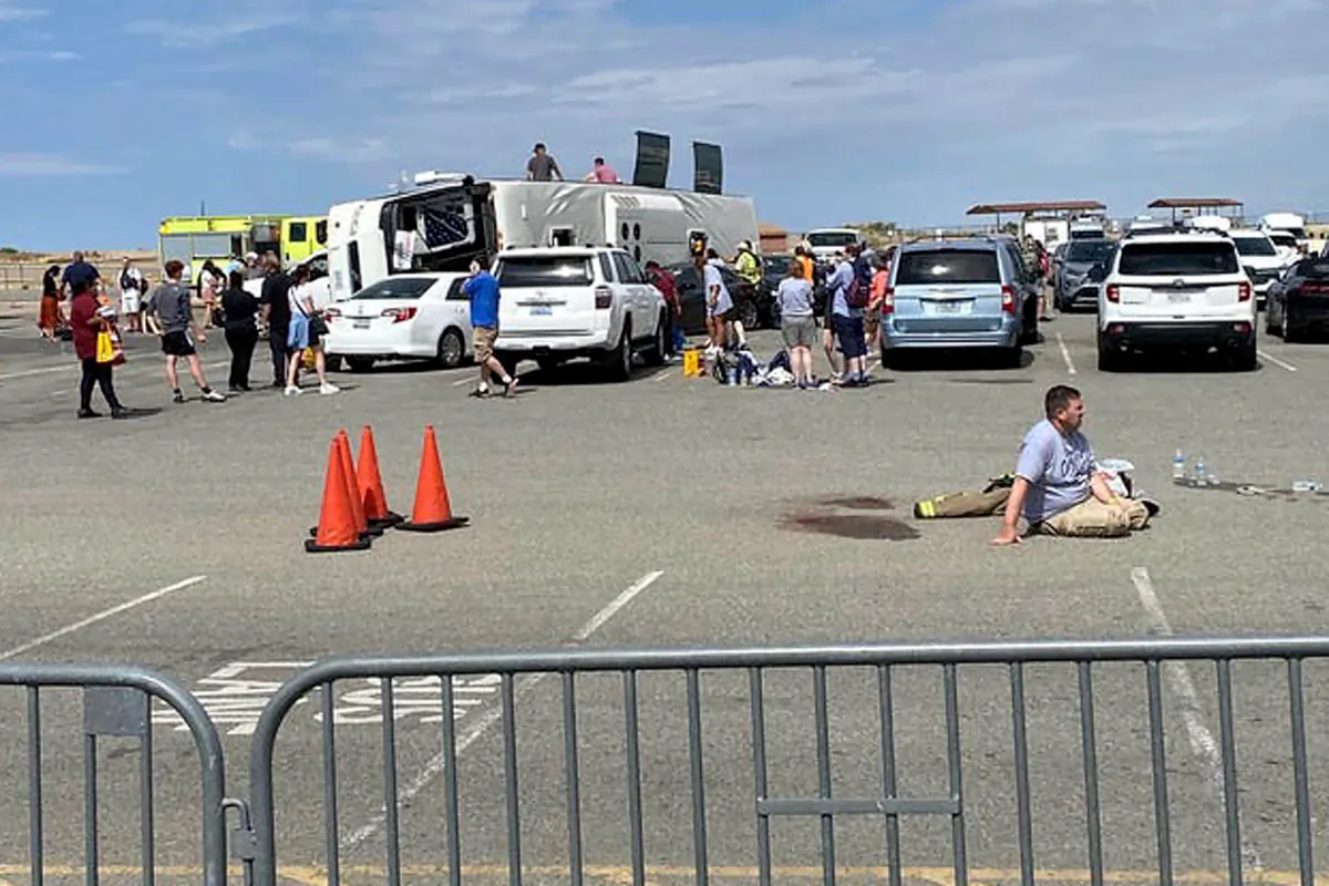 Emergency personnel tend to a crash after a tour bus rolled over in northern Arizona near the Grand Canyon West Skywalk, in Peach Springs, Ariz., on Aug. 1, 2023. (Mark McDowell via AP)