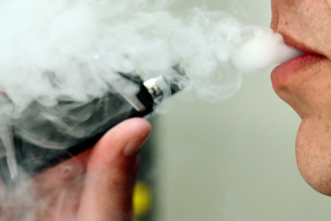 A man exhaling whilst using a vaping product on Feb. 21, 2020. A recent poll reveals that more than 4 in 10 smokers in Britain believe vaping is as dangerous or more dangerous than cigarettes,. (PA Media)