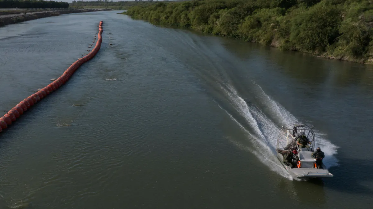 Texas Department of Public Safety troopers ride past buoys while patrolling the Rio Grande along the international boundary of the United States and Mexico near Eagle Pass, Texas, on July 29, 2023. (Adrees Latif/Reuters)