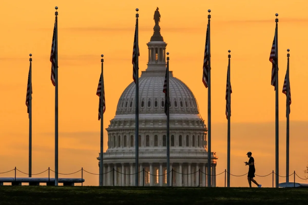 The U.S. Capitol  looms behind flags on the National Mall in Washington on Nov. 7, 2022. (J. David Ake/AP Photo)