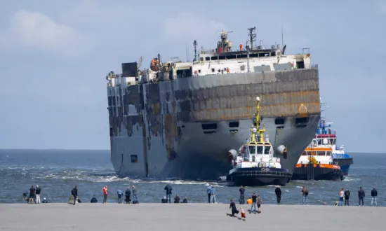 A Car-Carrying Ship That Burned for a Week on the North Sea Is Towed to a Dutch Port for Salvaging