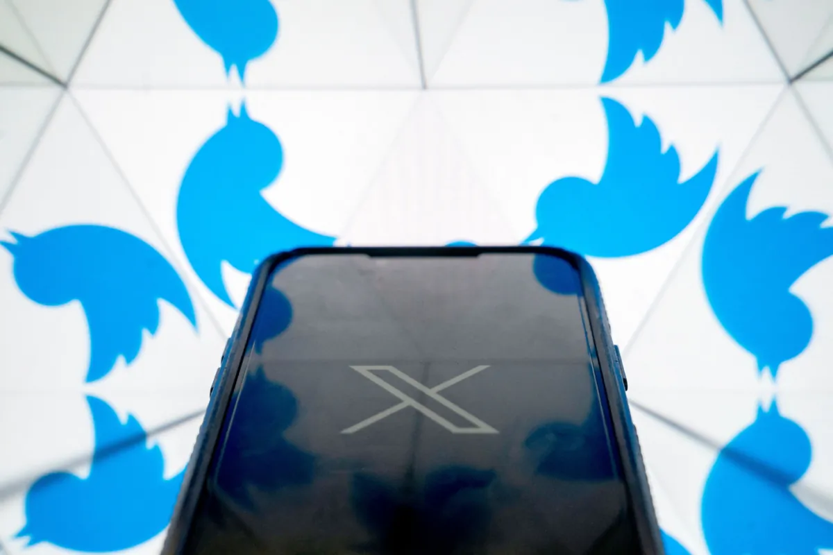 The new X Twitter logo in front of the bird Twitter logo in Washington on July 24, 2023. (Stefani Reynolds/AFP via Getty Images)
