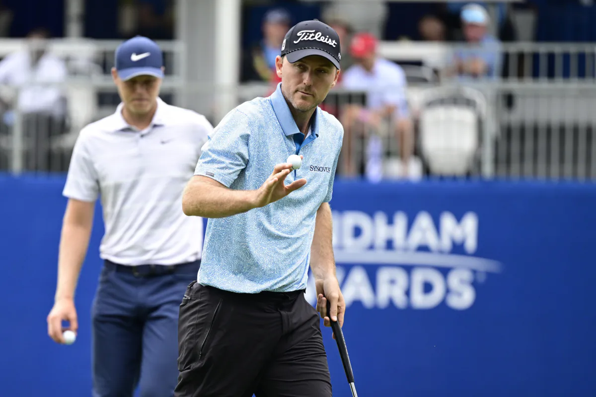 Russell Henley of the United States waves to the fans on the 18th green during the first round of the Wyndham Championship at Sedgefield Country Club in Greensboro, N.C., on August 3, 2023 (Logan Whitton/Getty Images)