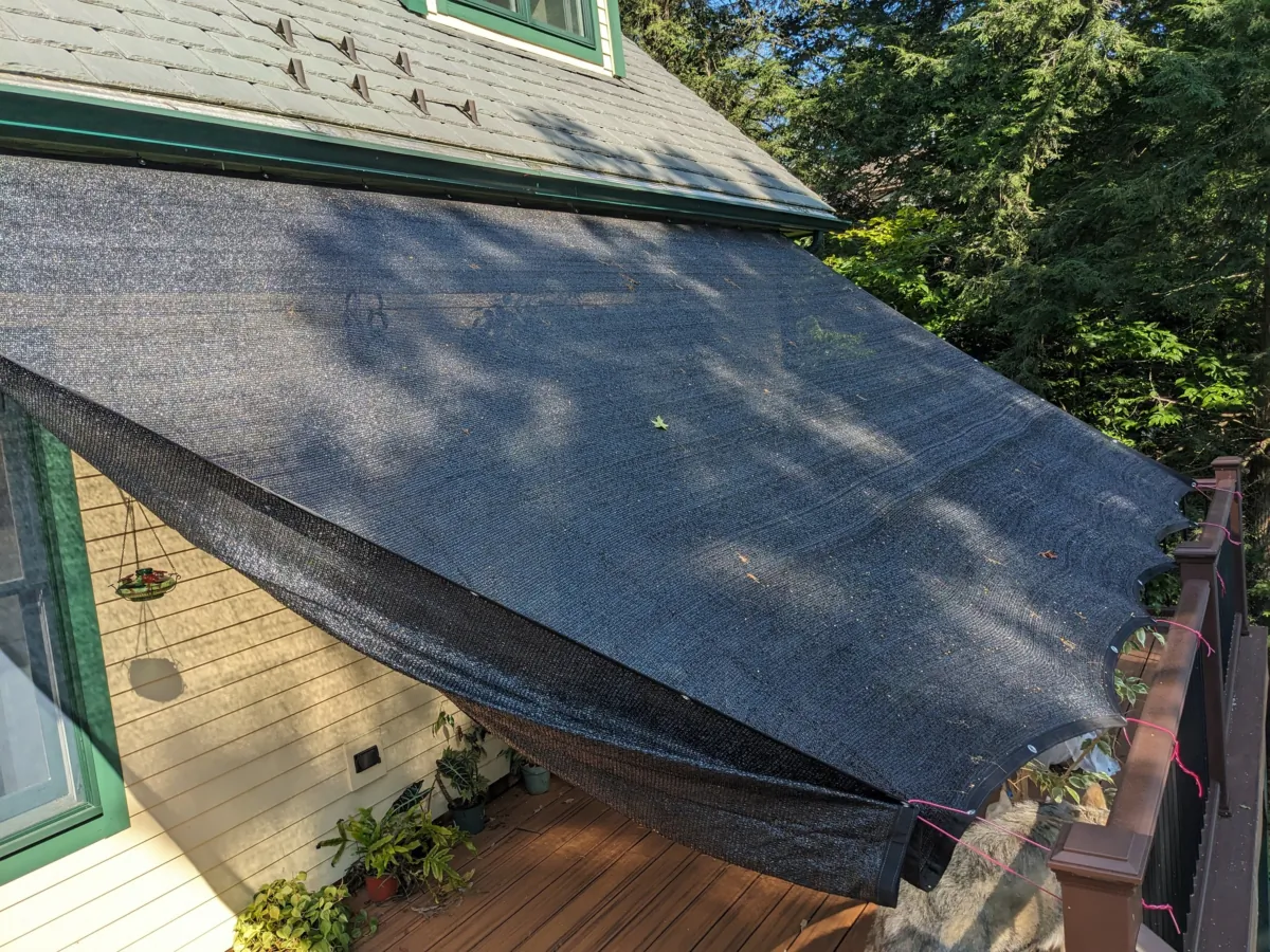 This inexpensive tarp controls the amount of sunlight that can pass through it. It may look ugly, but it keeps the room inside the house 15 degrees cooler. It's just one way to combat heat inside a home. (Tim Carter/Tribune Content Agency/TNS)