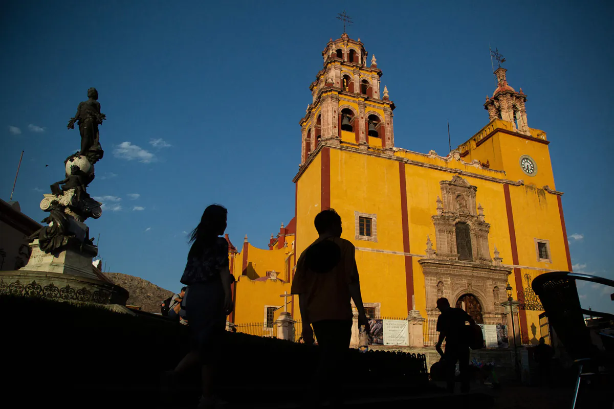Tourists walk in the streets of Guanajuato City, Mexico, on June 5, 2023. The mummies of Guanajuato are distributed in three museums in this municipality known internationally for its spectacular alleys and kilometers of tunnels, traces of a mining past. Most of them are displayed standing and in glass urns, with very little space between their skulls and the lights of the showcases. (Rodrigo Oropeza/AFP via Getty Images/TNS)