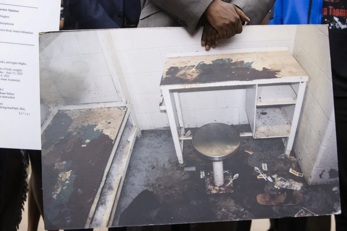 Attorney Michael Harper holds a photo of Lashawn Thompson's cell in the Fulton County, Ga., Jail, at the state Capital in Atlanta on May 22, 2023. (Christina Matacotta/Atlanta Journal-Constitution via AP)