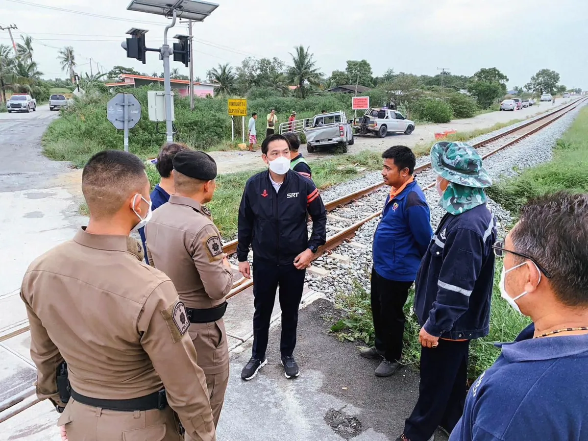 Gov. of the State Railway of Thailand Nirut Maneepan, (4th-L), talks to police at a crash site in Muang, Chachoengsao Province, Thailand, on Aug. 4, 2023. (Public relations of the State Railway of Thailand via AP )