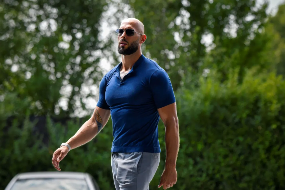 Andrew Tate walks in his yard after being released from house arrest and put under judicial control measures, on the outskirts of Bucharest, Romania, on Aug. 4, 2023. (Alexandru Dobre/AP Photo)