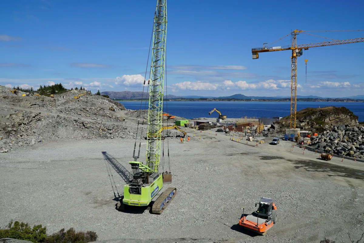 A photo taken on June 21, 2021 in Oygarden near Bergen, Norway, shows cranes and vehicles at a construction site at the start of construction work for a terminal which will collect liquefied carbon dioxide CO2, which will arrive by ship from industrial facilities in Europe and will run through a pipeline into geological formations deep beneath the sea bed, (Alexiane Lerouge/AFP via Getty Images)