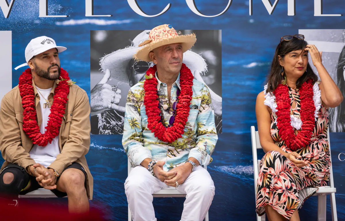 Surfers Hall of Fame inductees Italo Ferreira (L),  Fernando
Aguerre (C), and Laylan Connelly (R) sit together in Huntington Beach, Calif., on Aug. 4, 2023. (John Fredricks/The Epoch Times)