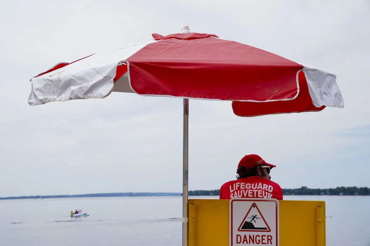 A lifeguards works at Brittany Beach of the Ottawa River in Ottawa on June 24, 2022. (The Canadian Press/Sean Kilpatrick)