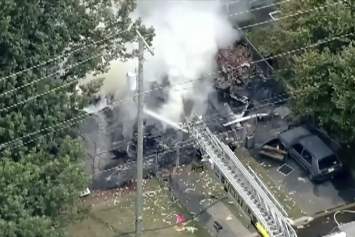 Fire crews try to extinguish a fire at a home in Buena, southern N.J., on Aug. 3, 2023, in a still from video. (WPVI-TV via AP)