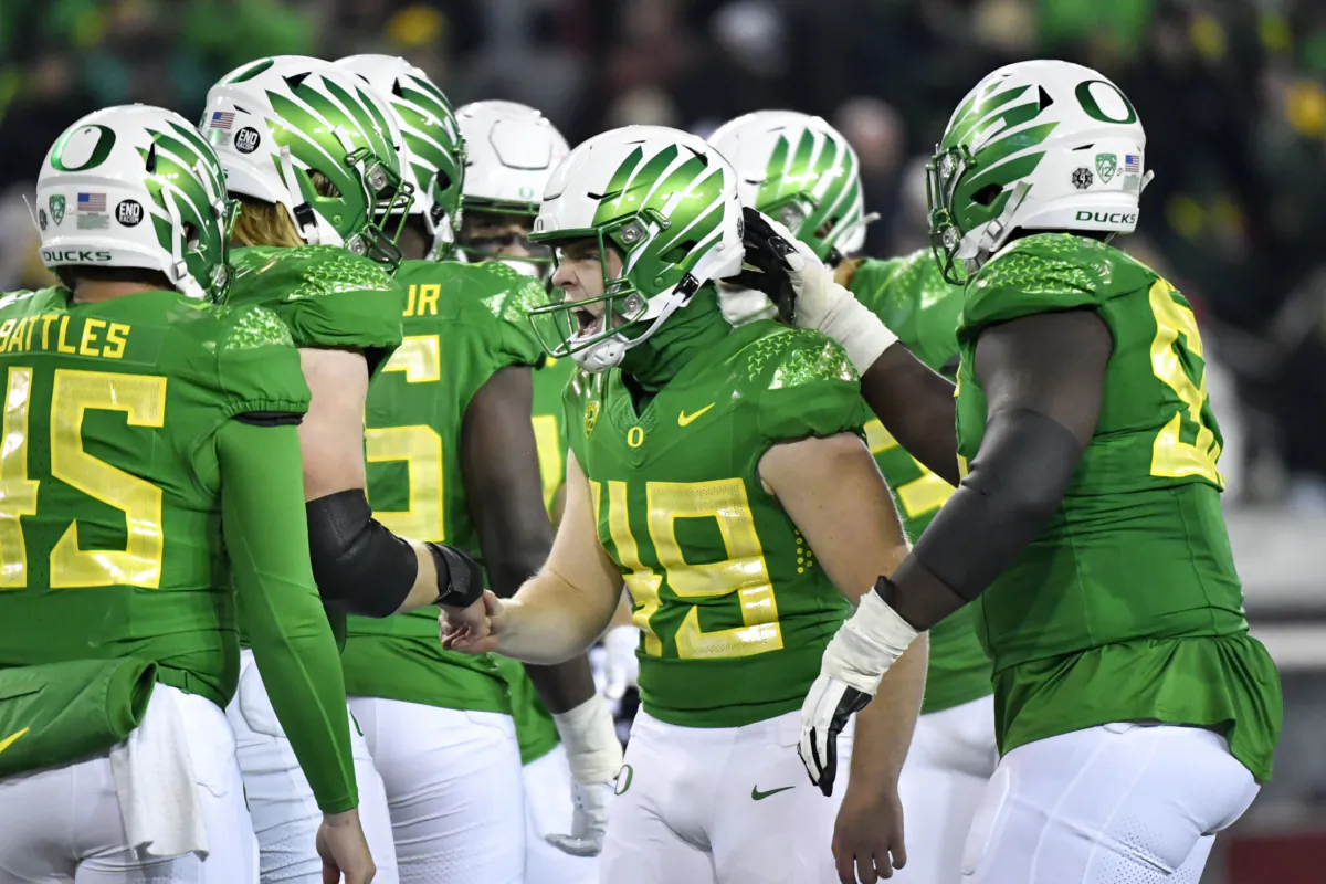 Oregon place kicker Camden Lewis (49) celebrates with teammates after kicking a field goal against Utah during the second half of an NCAA college football game in Eugene, Ore., on Nov. 19, 2022. (Andy Nelson/AP Photo)