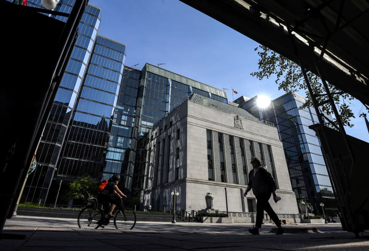 People pass the Bank of Canada building on Wellington Street in Ottawa in a file photo. (The Canadian Press/Justin Tang)
