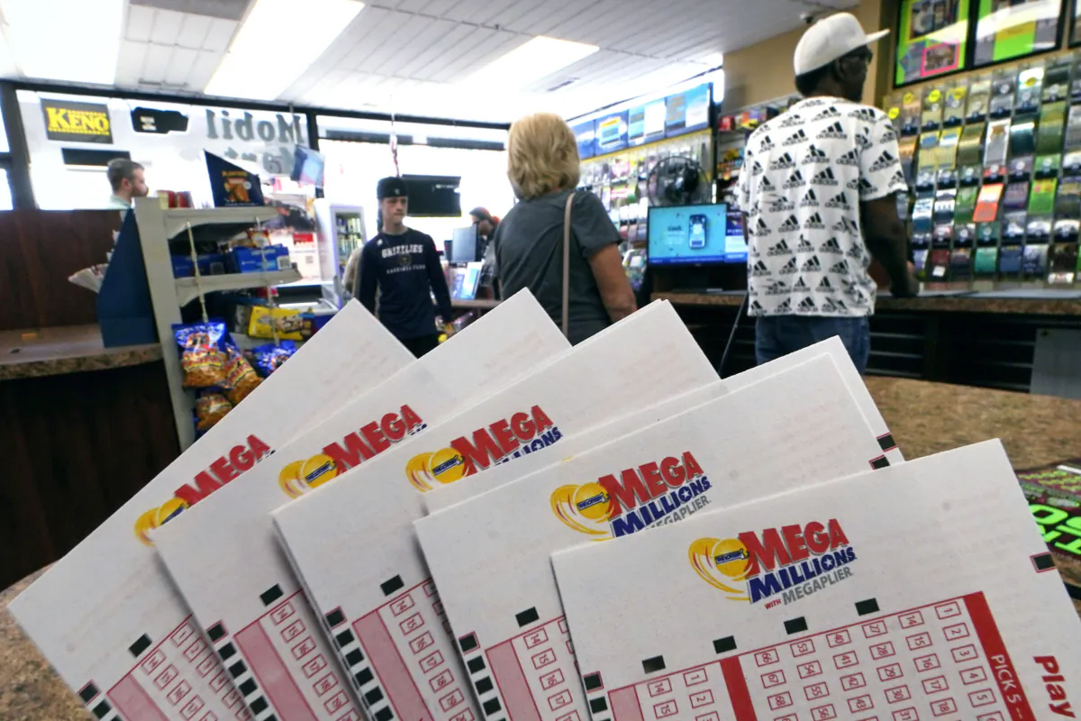 Customers wait in line to buy tickets ahead of Friday night's Mega Millions lottery drawing at Ted's State Line Mobil in Methuen, Mass., on Aug. 3, 2023. (Charles Krupa/AP Photo)
