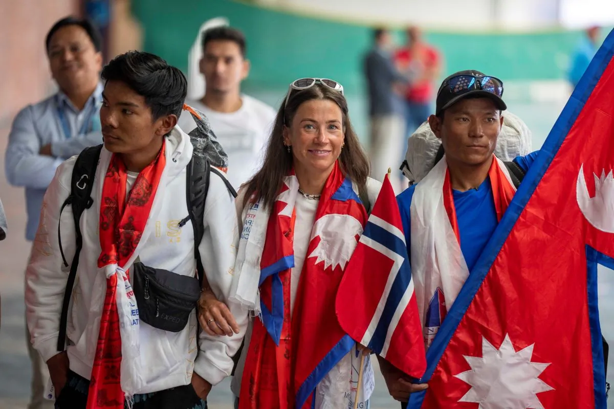 Norwegian woman mountain climber Kristin Harila, (C), and her Nepali Sherpa guide Tenjen Sherpa, (R), arrive at the airport in Kathmandu, Nepal, on Aug.5, 2023. (Niranjan Shrestha/AP Photo)