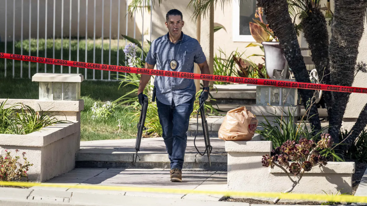 Investigators remove firearms from a house in the 8500 block of E. Canyon Vista Dr. in Anaheim, Calif., on Aug. 4, 2023. (Paul Bersebach/The Orange County Register via AP)