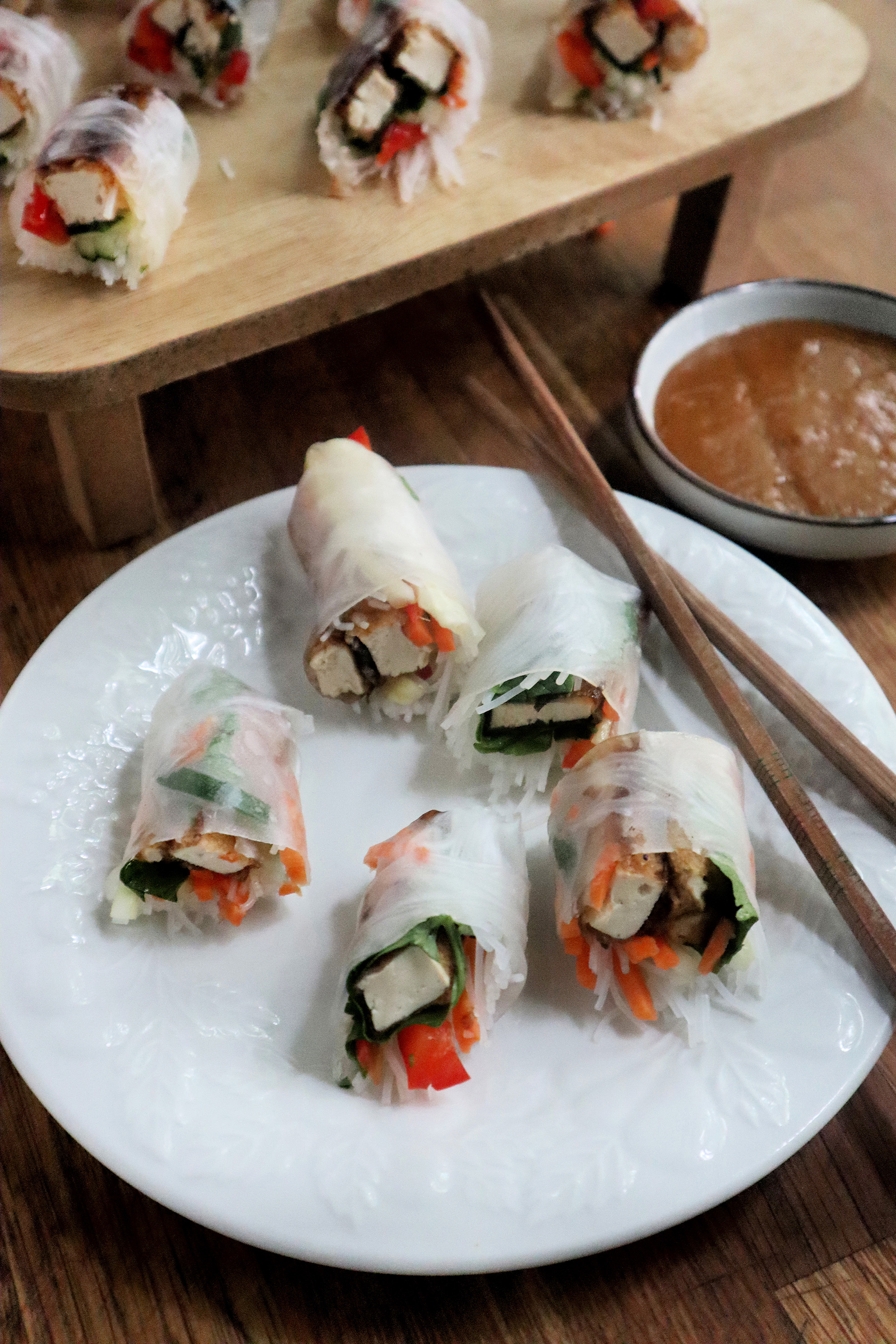 Fried tofu is rolled up with fresh veggies and herbs for a vegetarian summer roll.