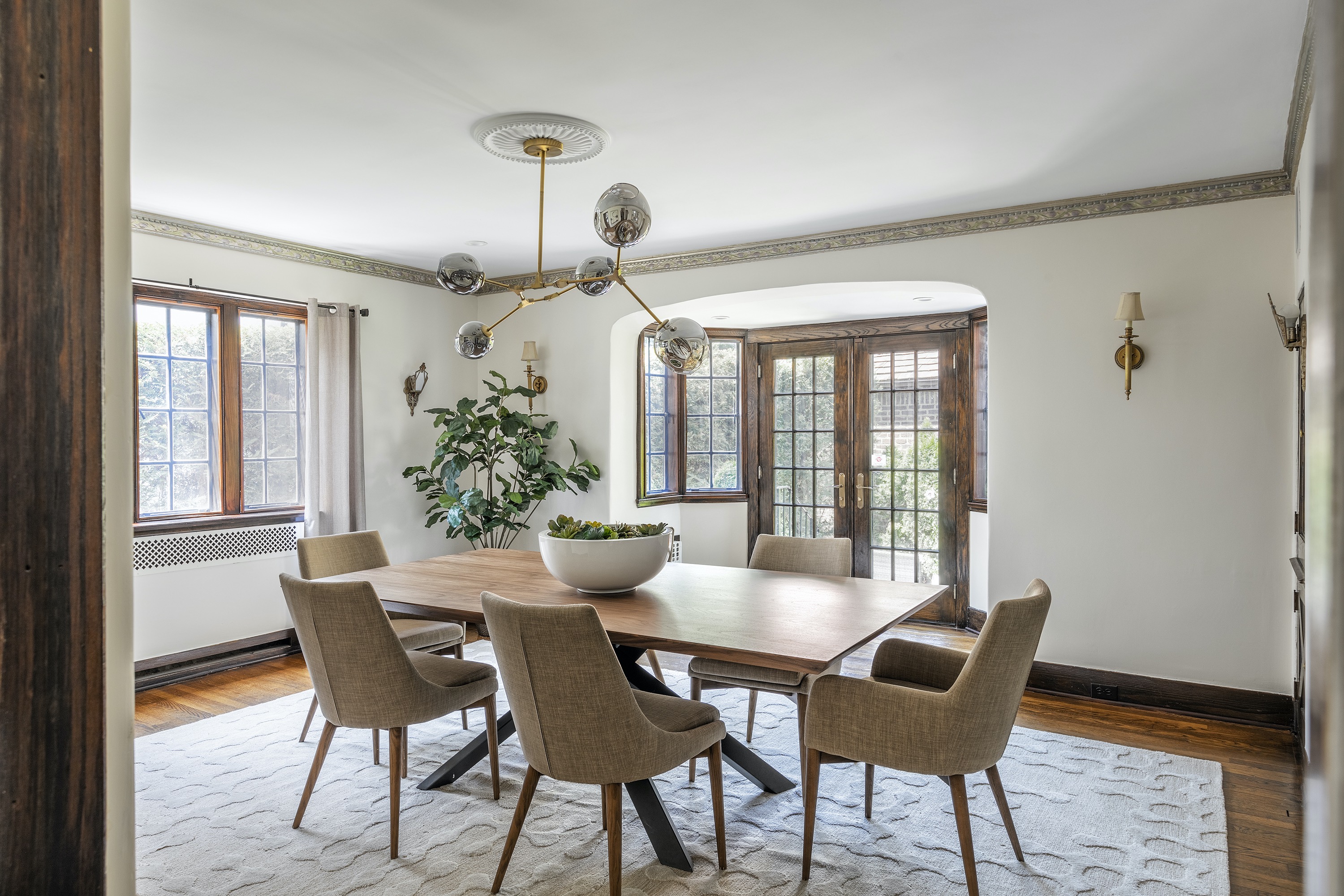 A large, round vase filled with succulents creates a modern feel in a traditional space.